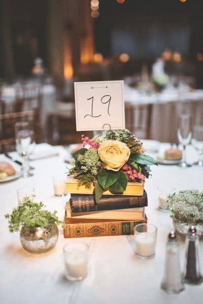DIY Centerpieces  -  Books topped with Flowers
