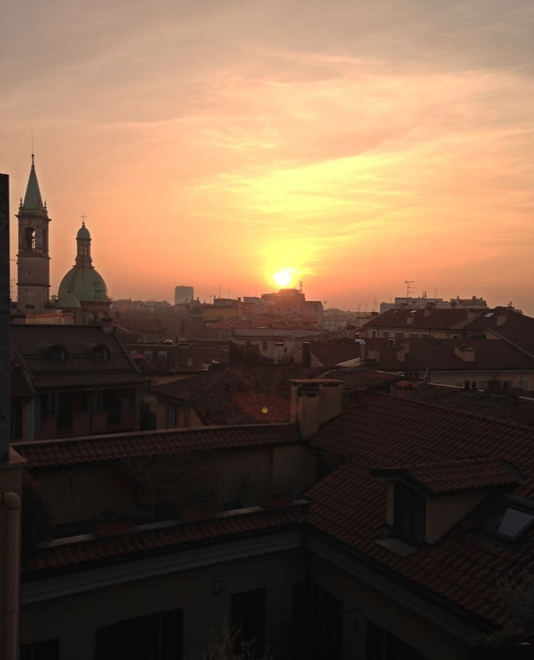 Travel Diary Milan: the red roof tops of the city at sunset