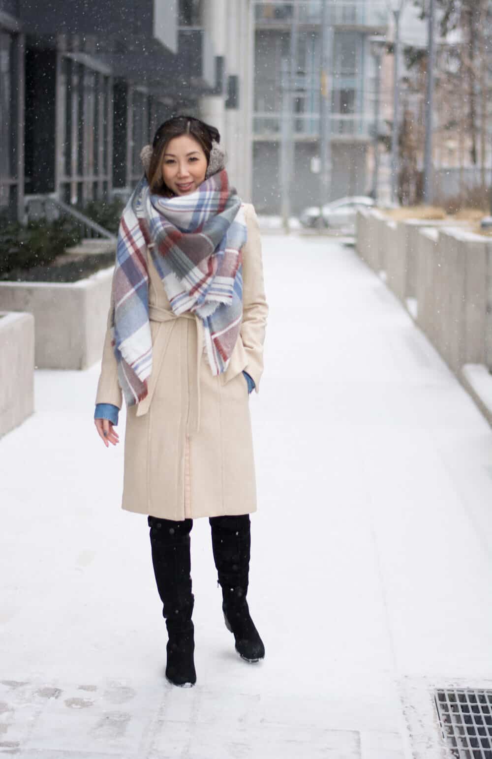 Cosy Winter OOTD streetstyle look: plaid scarf and long wool coat, fur ear muffs