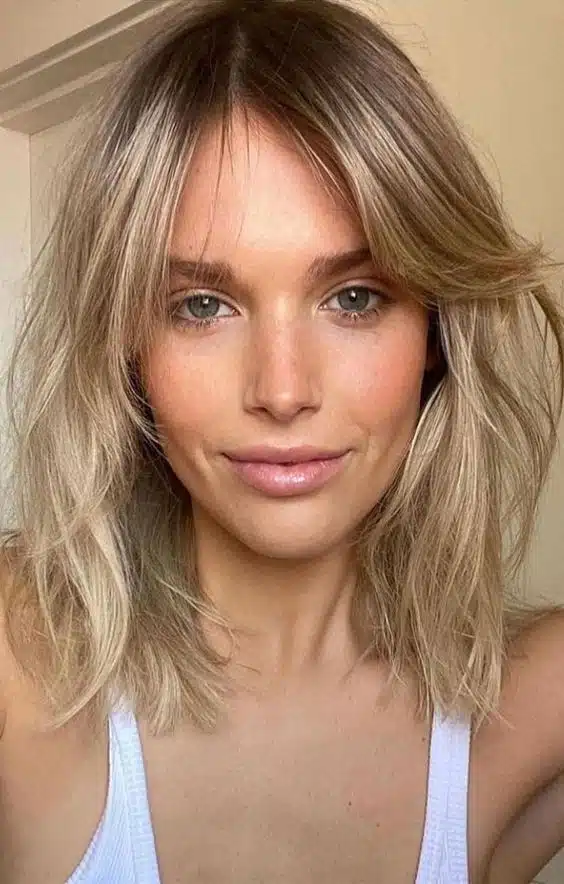Medium hairstyles for women - A long bob with curtain bangs is a great haircut that looks good on different face shapes! 