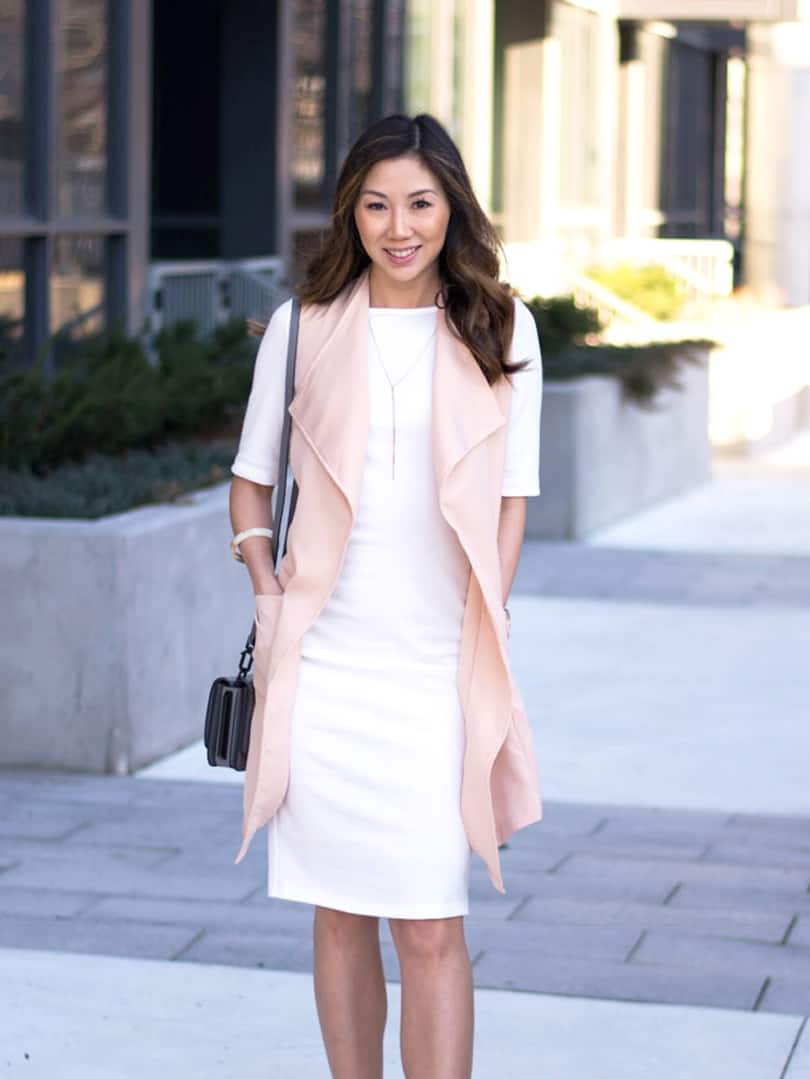 Spring look with white dress and pink vest.
