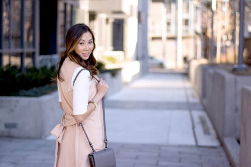 Spring look with white dress and pink vest.