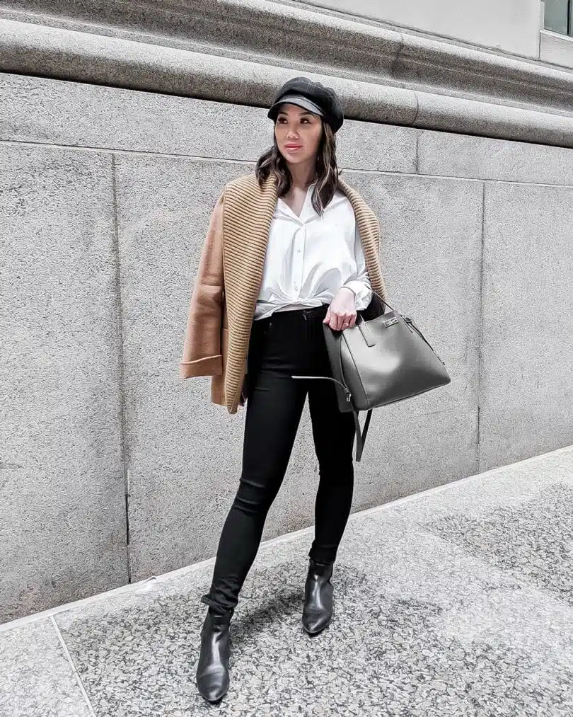 Workwear Office Oufit - white blouse, black jeans, camel coat, and newsboy cap