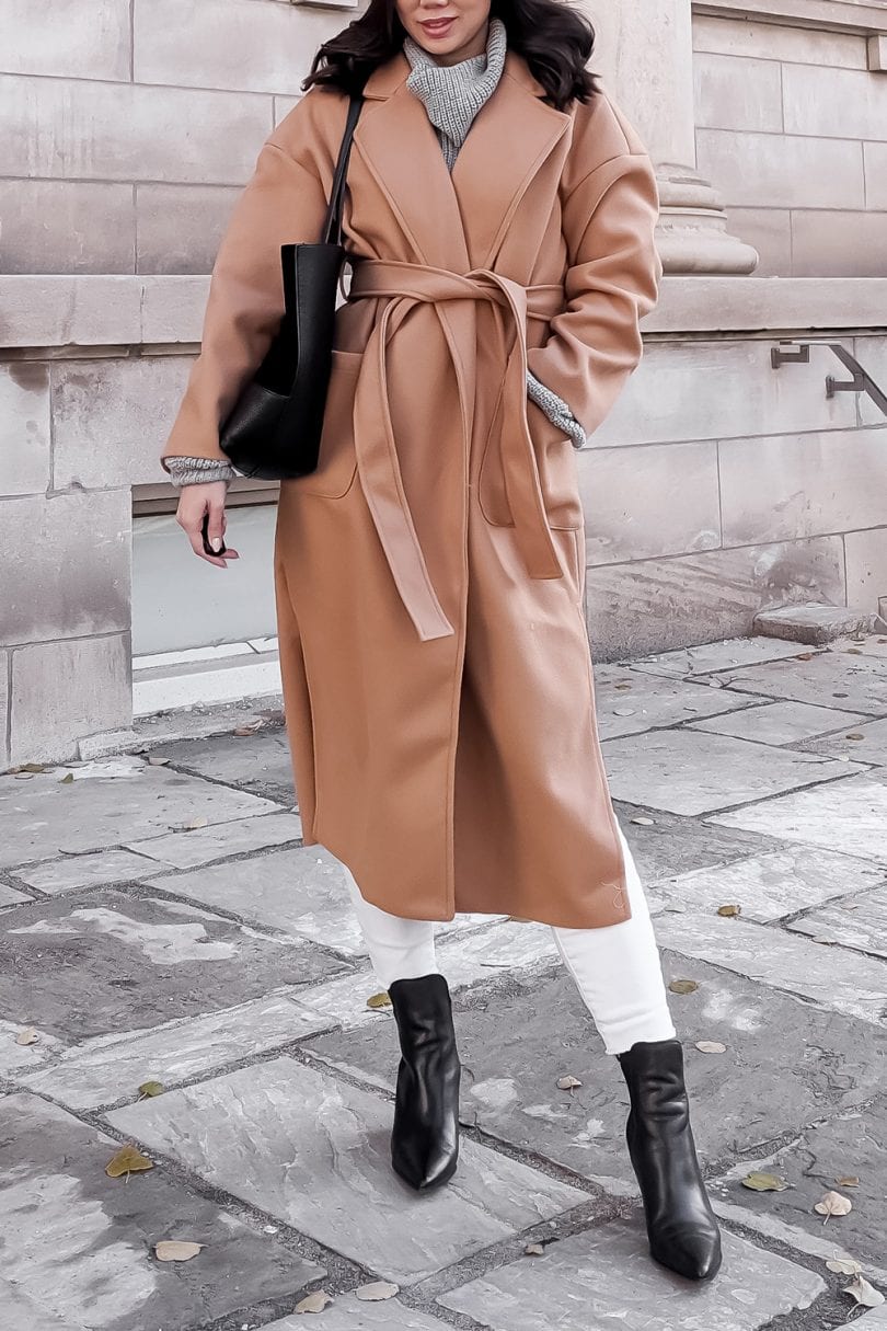 Winter outfit details - long camel wool coat with white jeans and ankle booties