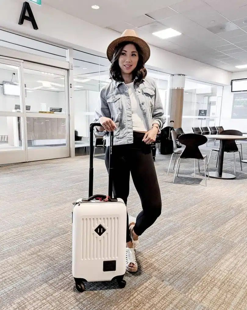 Black leggings outfit for travel with tshirt and jean jacket worn by Eileen Lazazzera ofHigh Quality Luxury Shopping