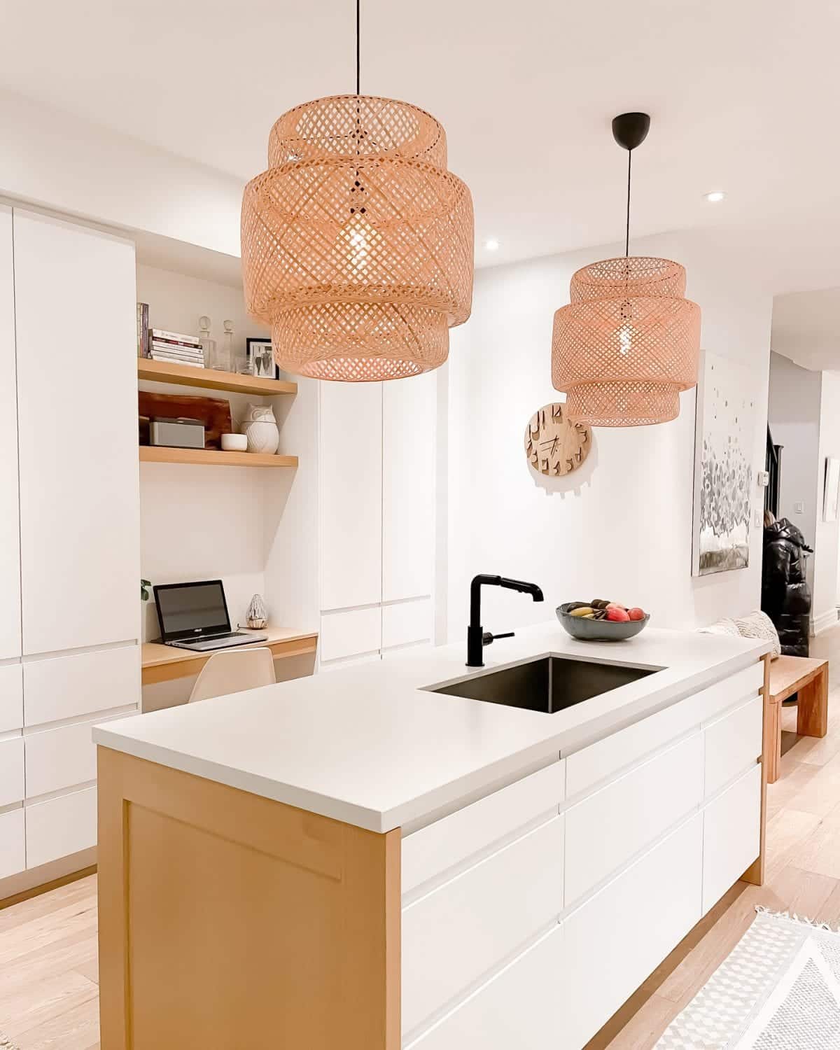 Kitchen desk area - white kitchen with wood accents and basket pendant lights.