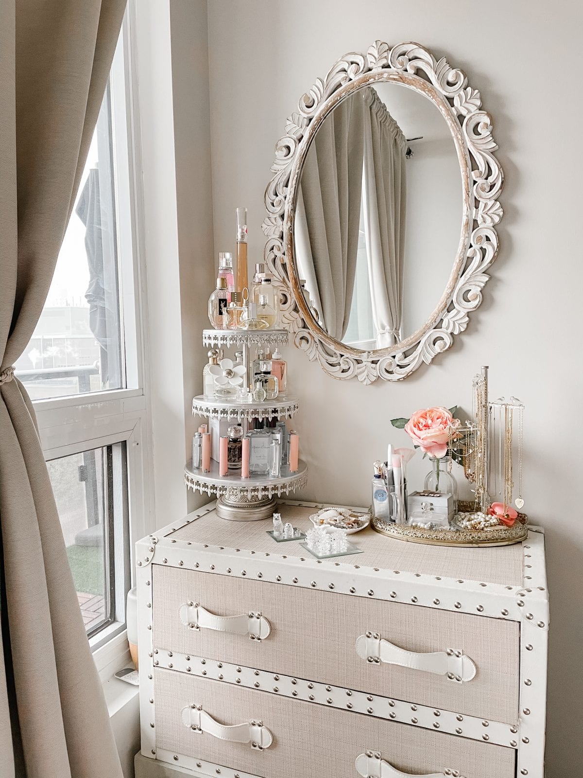 Bedroom vanity area with cake stand for perfume and makeup