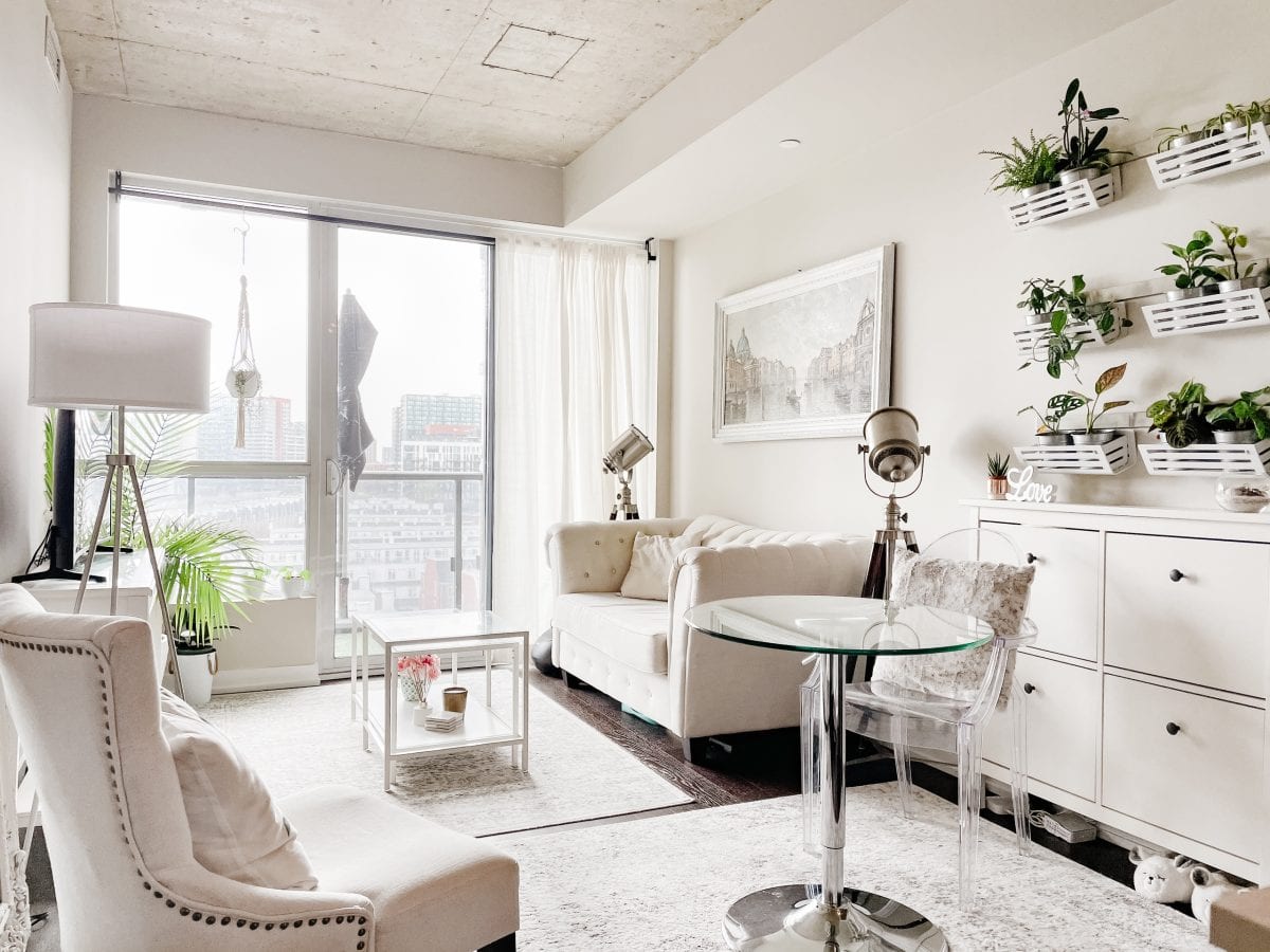 Condo tour - white boho chic condo living room with plant wall