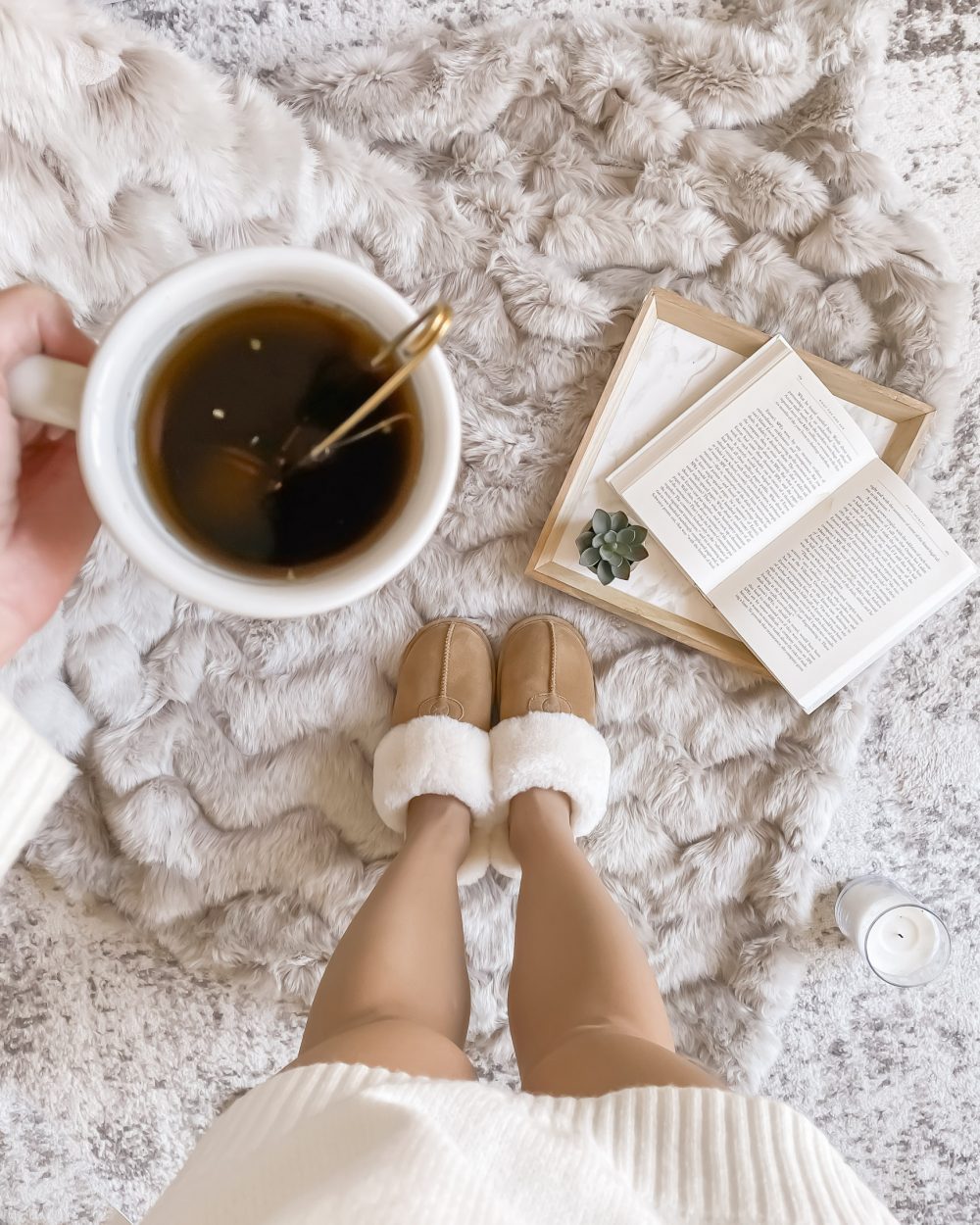 That hygge feeling when you cozy up with a cup of hot tea, a book and some sheepskin slippers. Image from yesmissy.com