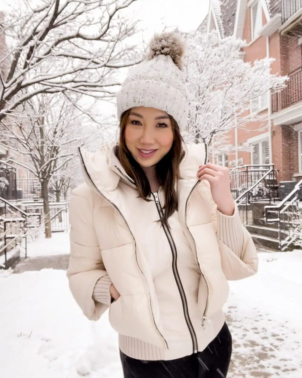 Cute winter outfit with white puffer jacket and pom pom beanie. Get more details on this winter look on yesmissy.com