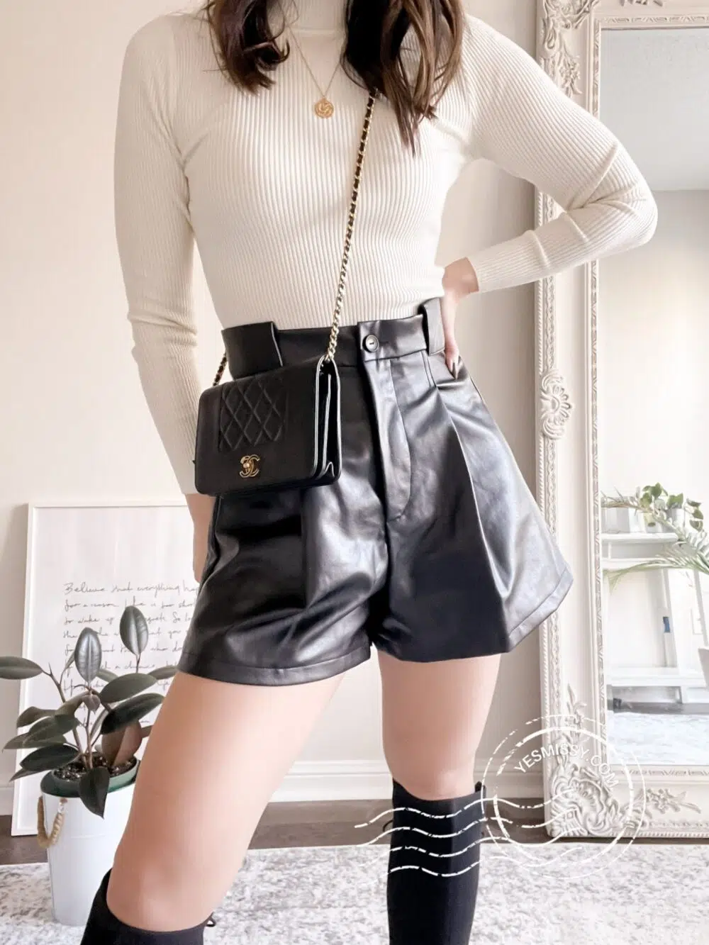 leather shorts outfit with mock neck sweater, Chanel WOC bag, knee high boots