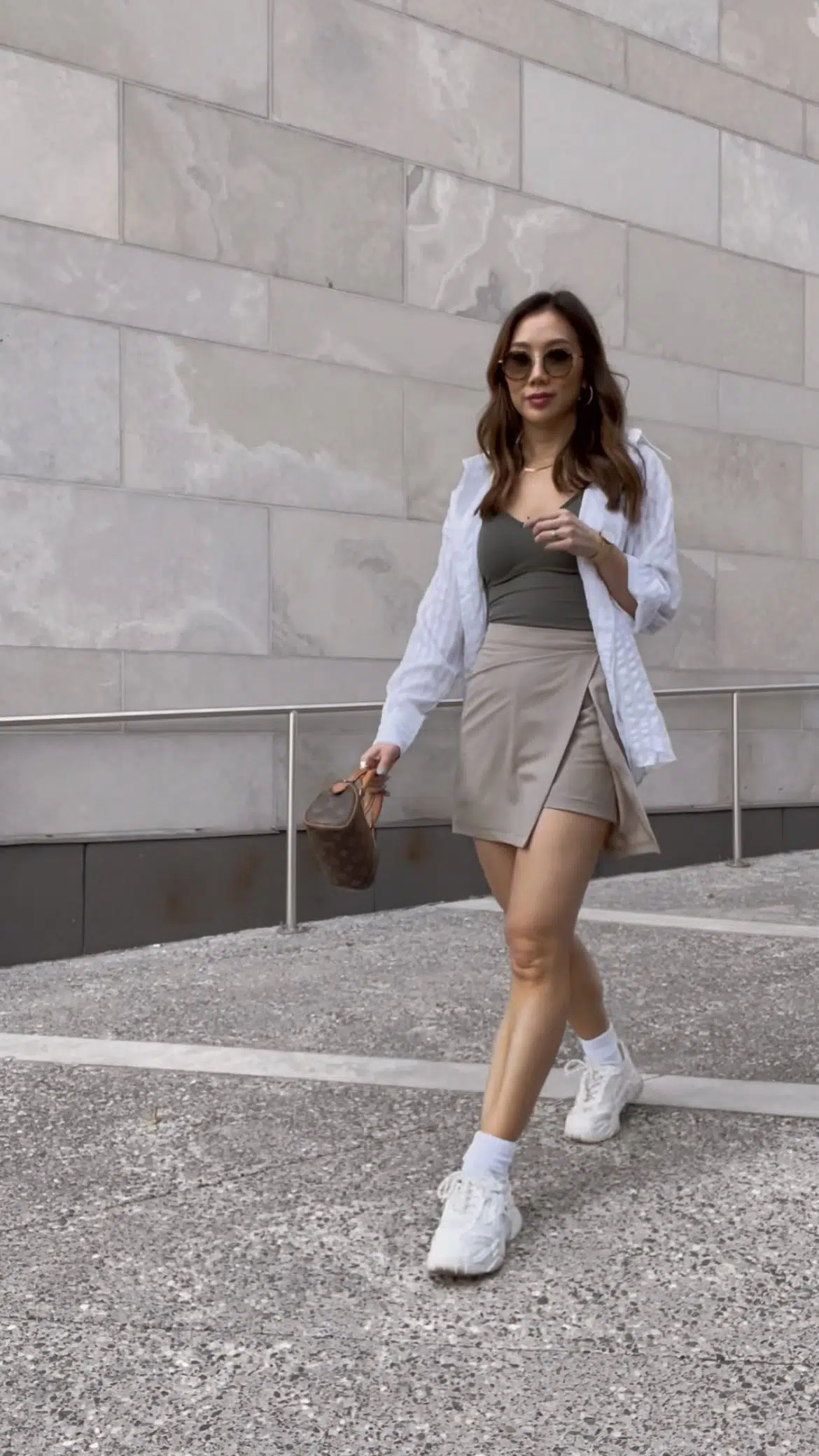 Toronto street style - summer casual outfit with skorts, tank and button down shirt with sneakers. Outfit details on yesmissy.com