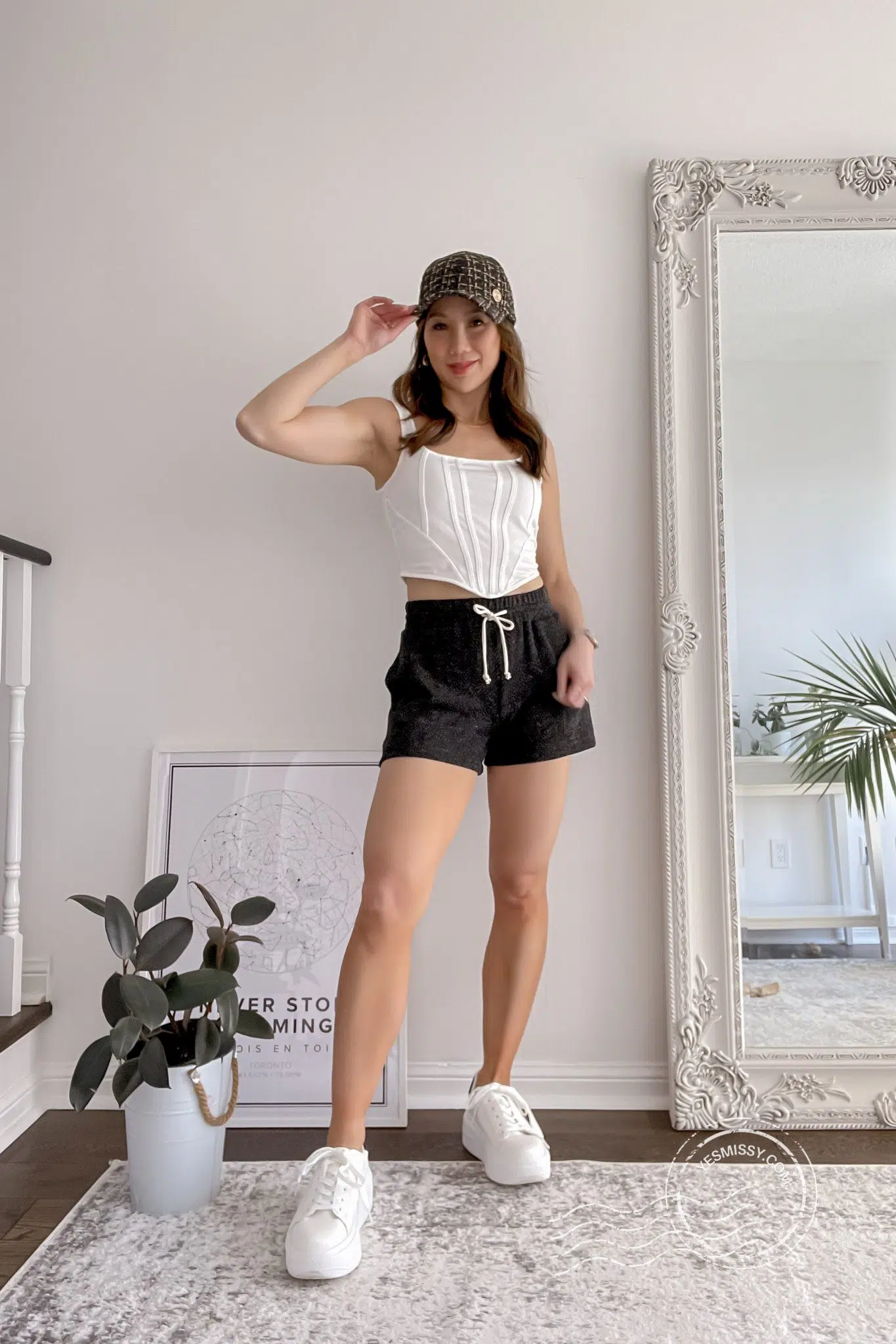 Casual sporty look for summer - drawstring shorts, corset tank and baseball cap. Get more summer outfit inspo on yesmissy.com