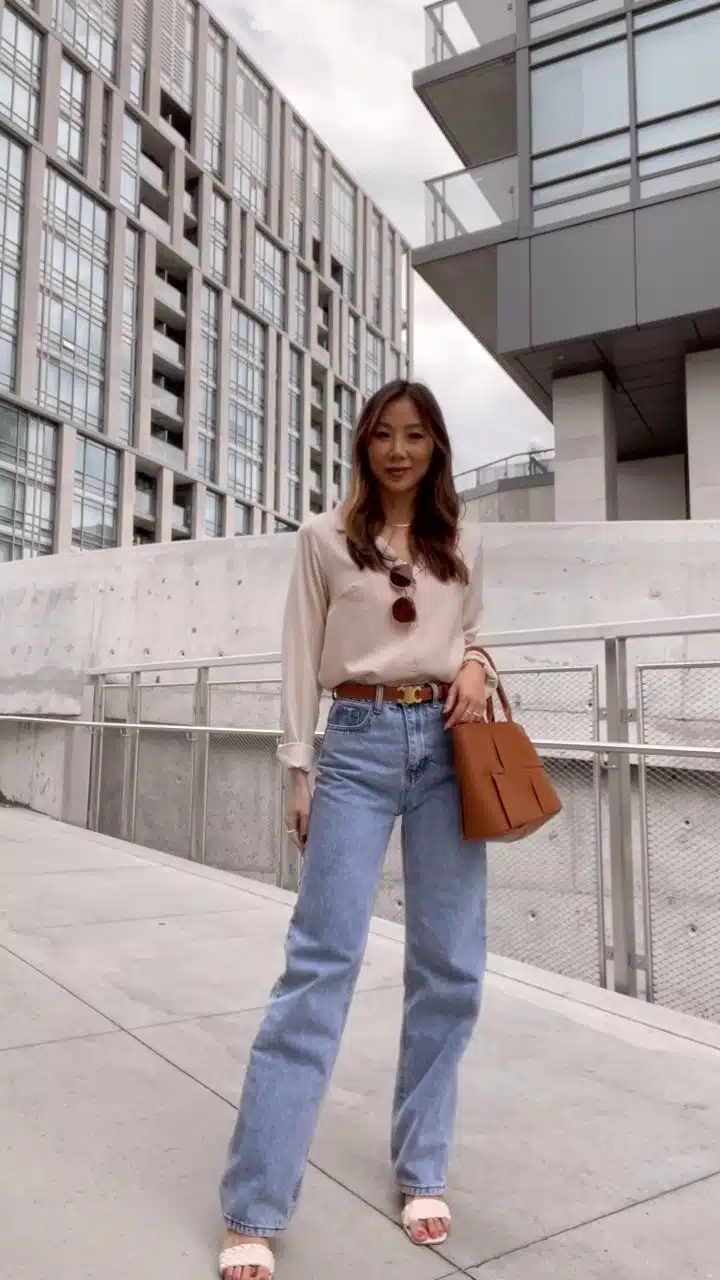 Casual chic look with satin blouse and wide leg jeans with brown woven bag and Celine belt. More fall outfit ideas on yesmissy.com