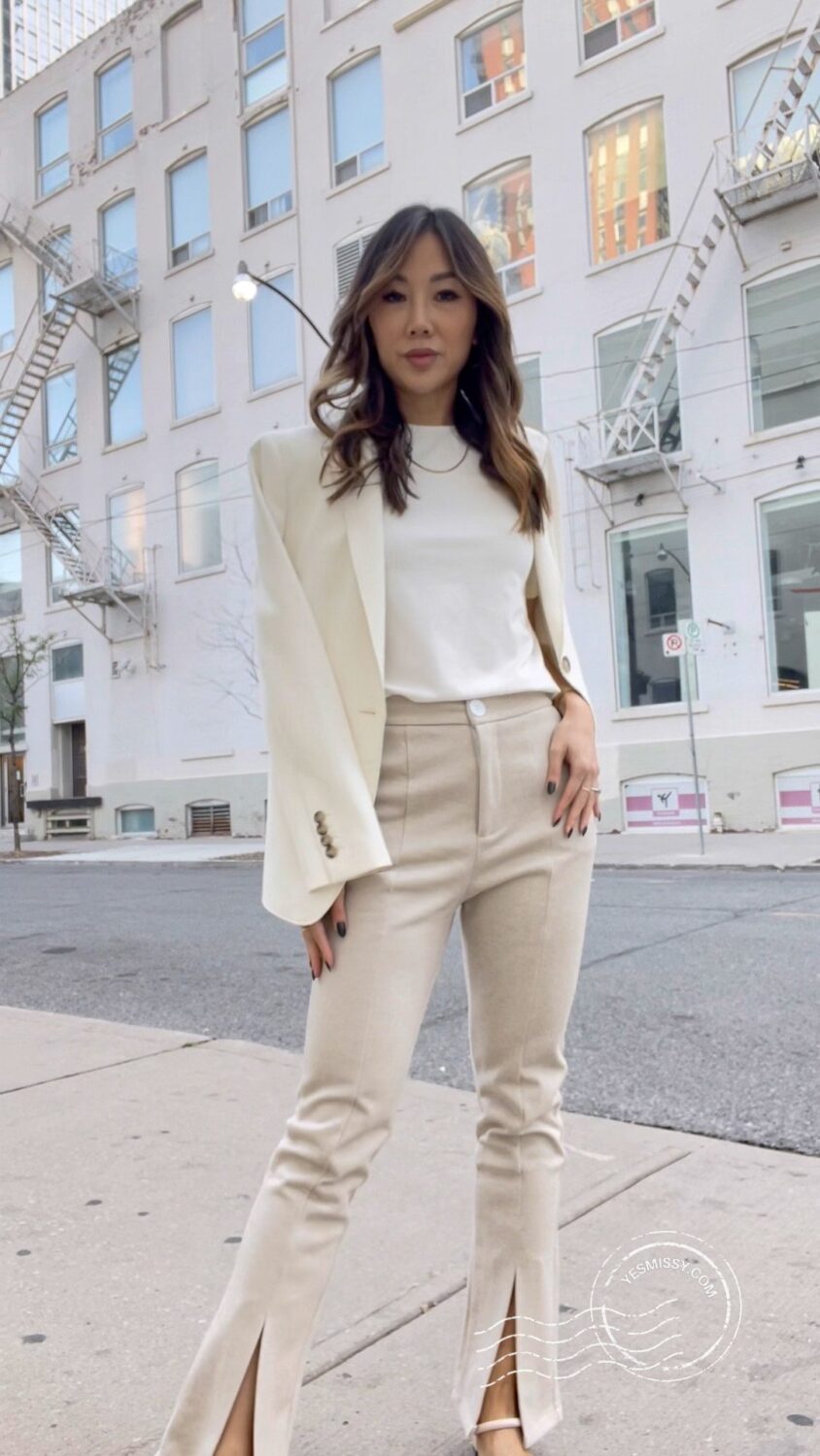 Streetstyle look with white blazer and beige split hem pants. 