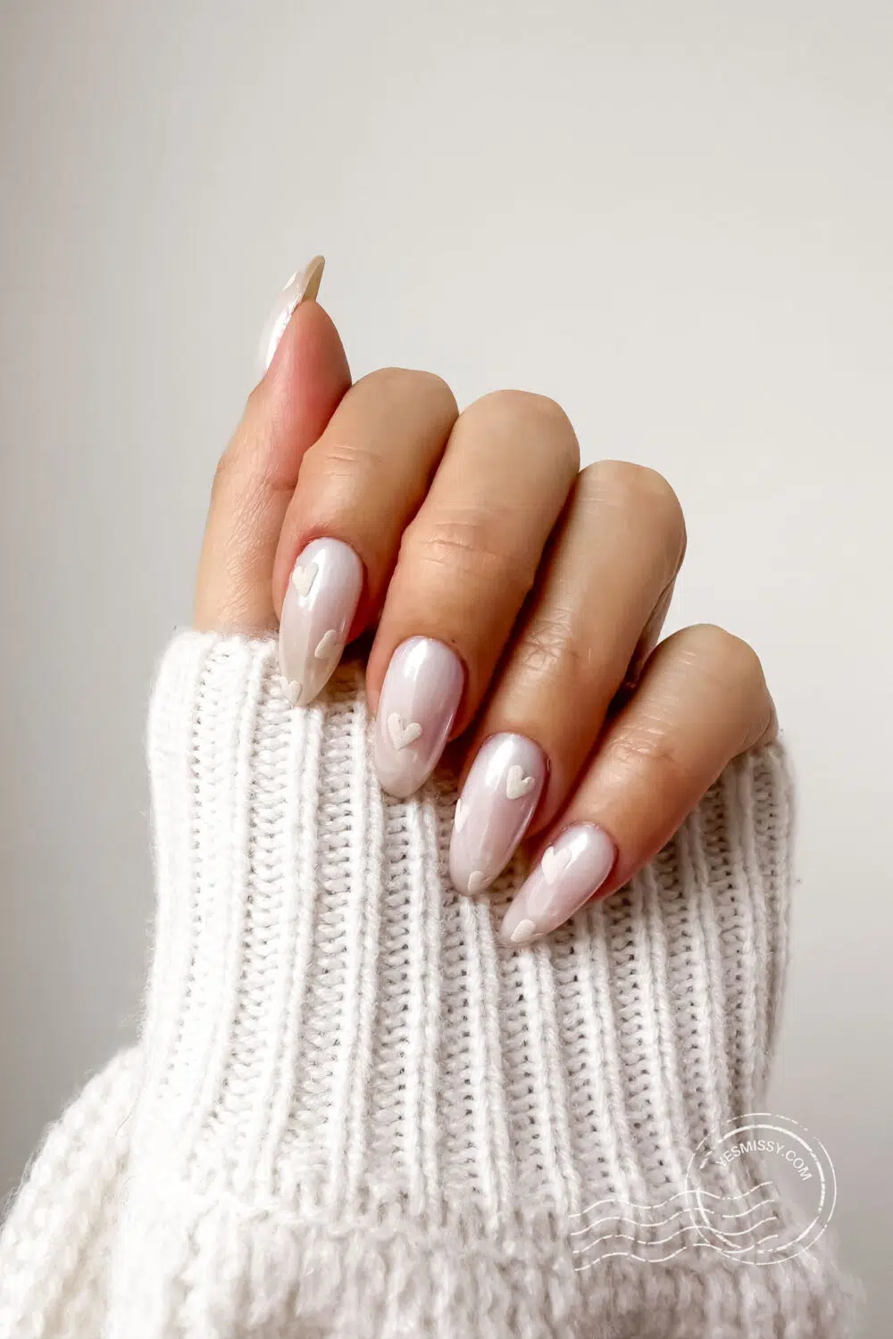 Nail inspiration: Soft matte hearts on a glossy neutral base create an effortlessly chic and understated Valentine’s manicure. More nail inspo on yesmissy.com