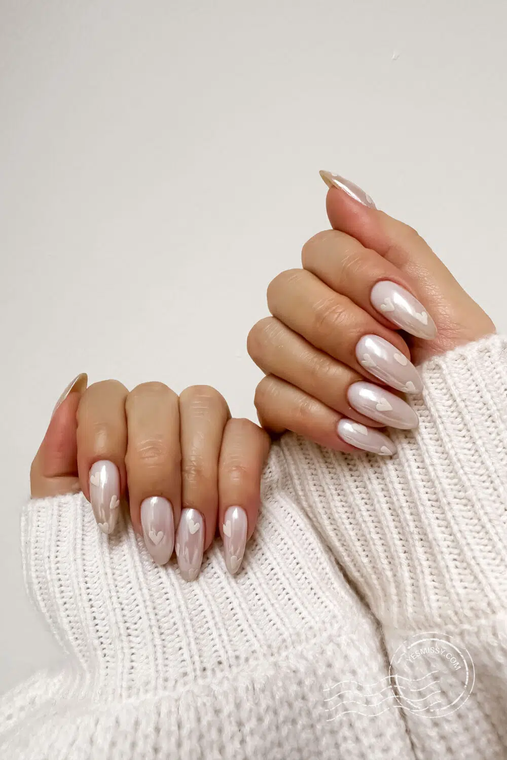 Nail inspo: A glossy neutral base with soft matte hearts creates a chic, minimalist vibe—effortlessly romantic and perfect for a quiet luxury look