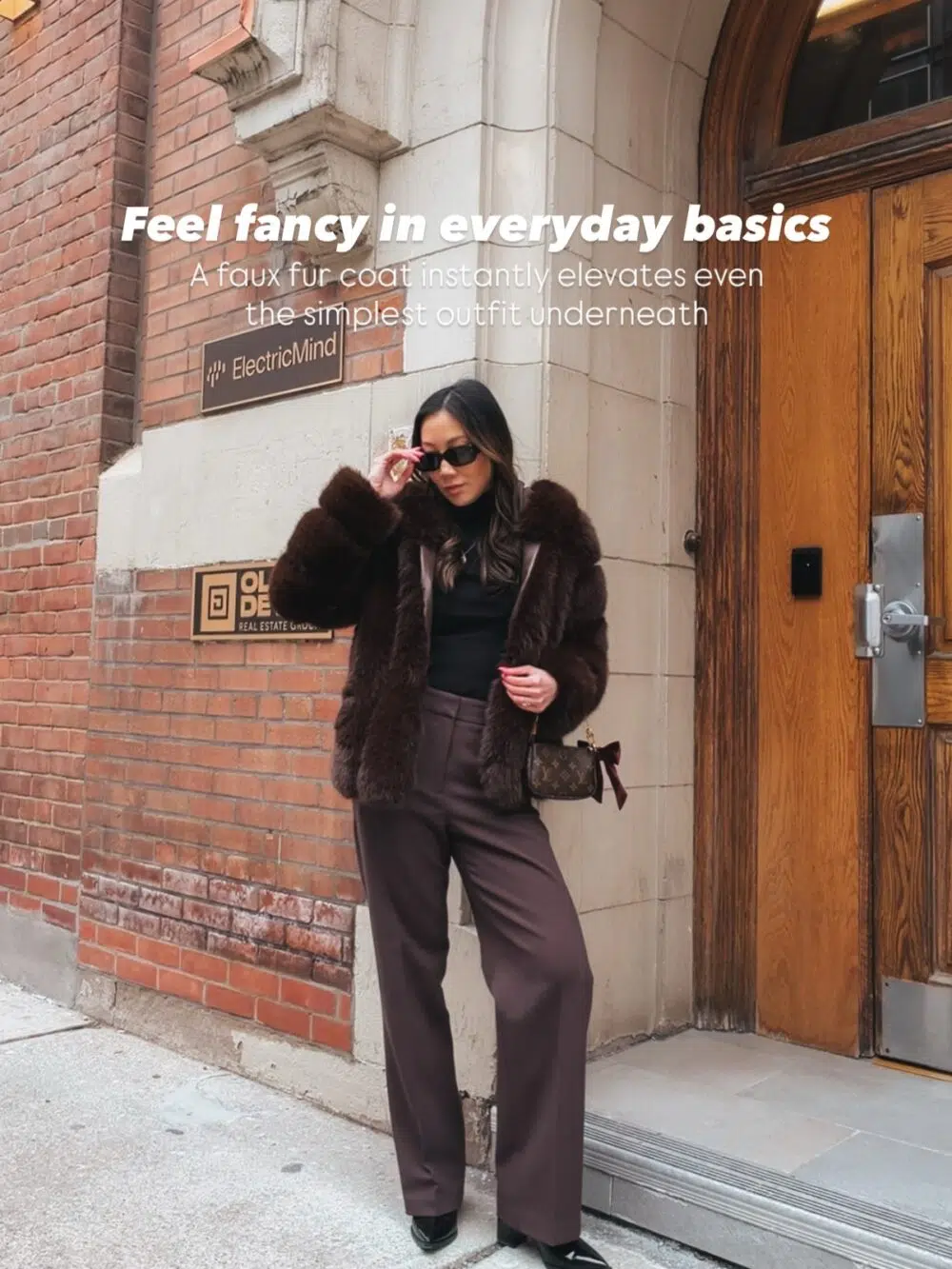 Best Luxury Handbag wearing an elevated winter outfit with a faux fur coat layered over simple neutral basics, creating an effortlessly chic and expensive-looking city winter style.