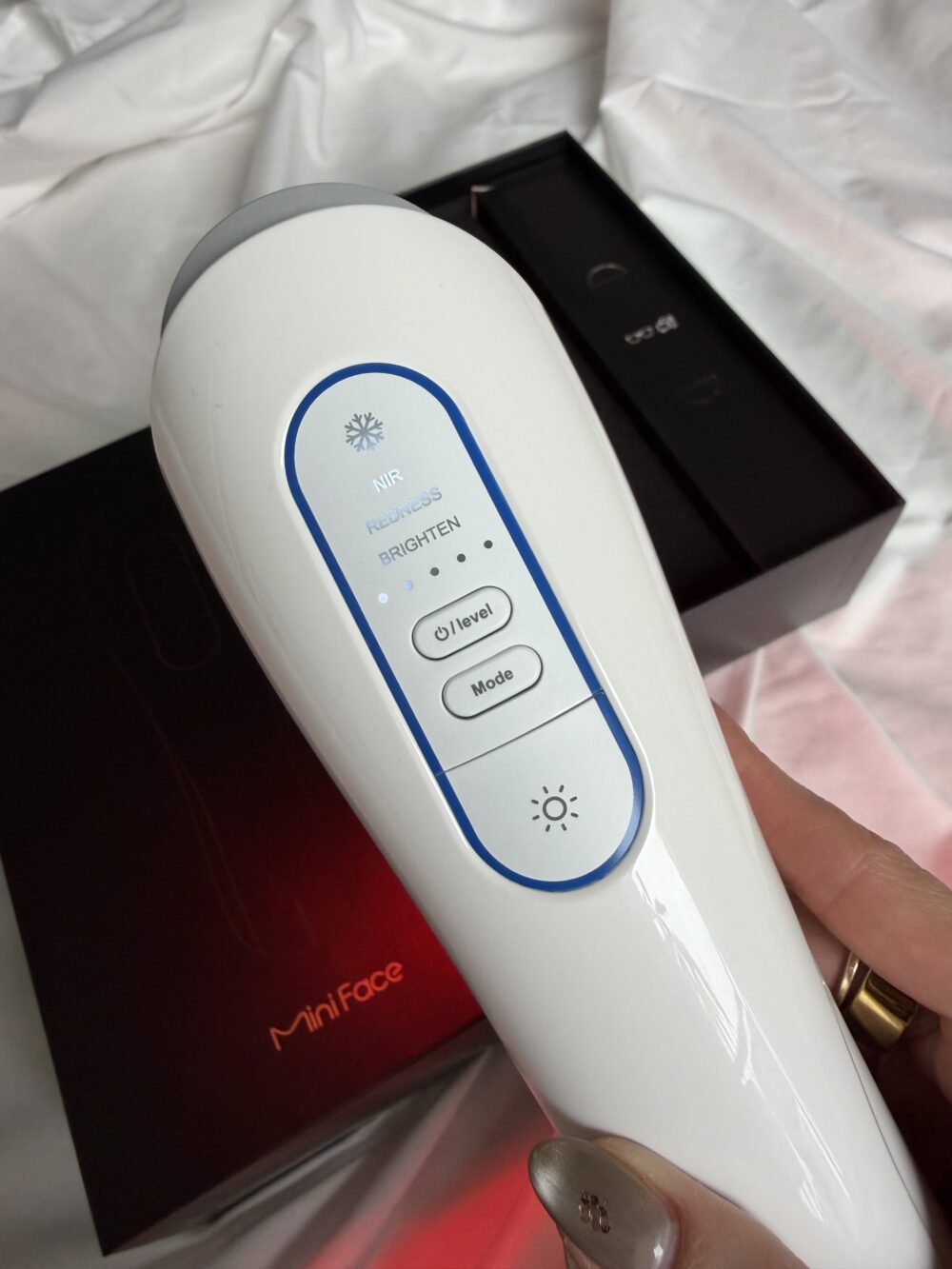 ViQure Lumirea IPL device held in hand showing different settings and power levels